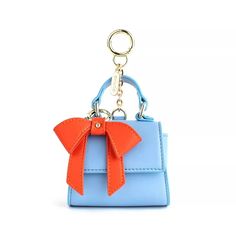 We know how much you love our classic Cottontail bag so we “honey I shrunk it! Scoop up this cute mini version and use it as a bag charm or a keychain or both. Large enough to hold your AirPods, keys, or small change, the Cottontail mini is sure to steal your heart while keeping your belongings secure with its magnetic closure. We even made its bow removable! So buy it in as many colors as you like and swap the bows to customize. 

Dimensions:
3.75W x 5.25H x 2.25D Gift Keychain With Logo Charm, Logo Charm Keychains For Gifts, Logo Charm Bag For Everyday Use, Everyday Bag Charm With Lobster Clasp, Rectangular Keys Bag Charm For Gift, Trendy Bag Charm As A Gift, Rectangular Bag Charm With Key Clip, Trendy Rectangular Keychain With Key Clip, Rectangular Logo Bag Charm