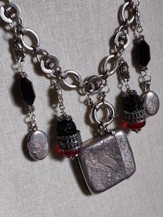 a necklace with charms and coins hanging from it