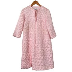 This vintage pink robe from Vanity Fair provides a stylish and comfortable option for your loungewear collection. The robe features a classic design with a soft, flowy material that drapes elegantly over your body. The brand's attention to detail is evident in the delicate lace trim around the cuffs and neckline, adding a feminine touch to the overall look. Perfect for lazy weekends or cozy evenings at home, this robe is a great addition to any wardrobe. It's a beautiful piece of vintage clothin Long Sleeve Pink Nightgown For Spring, Feminine Spring Nightgown For Loungewear, Spring Feminine Nightgown For Loungewear, Spring Feminine Loungewear Nightgown, Spring Vintage Robe For Loungewear, Vintage Spring Loungewear Robe, Spring Vintage Loungewear Robe, Pink Feminine Robe For Sleepover, Feminine Pink Robe For Sleepover