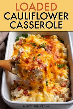 loaded cauliflower casserole in a white dish with a wooden spoon