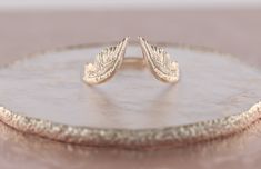 Fab and Sophisticated Angel Wings band in Bohemian Chic style. It has a comfortable fit inside the shank and you won't want to take it off! About this item: -Available in 10K/14K/18K gold in Rose/Yellow/White colors PLEASE NOTICE: This price is for the ring's sizes up to 8, if you need a bigger size > contact us for price & details! Please allow up to 1-2 weeks for production, as each item is made to order! You may also like: https://www.etsy.com/listing/777502252/pink-sapphire-engagement Engagement Rings With Wings, Rings With Wings, Elegant Winged Gold Jewelry, Angel Wing Ring Gold, V Wedding Band, Bohemian Chic Style, Wings Band, Wing Ring, Nature Wedding Ring