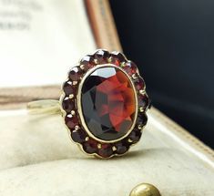 Beautiful rare antique German ring, 14k gold garnet ring, the ring face measures 13x 17 mm, US Size 8 1/2, the ring is in good condition. Box on the photos not included! Material: 14k gold, garnet total weight: approx. 4.8g US Size: approx. 8 1/2 (EU size 58) A stunning religious shop well worth a visit ... https://etsy.me/2NNNK4g Antique Red 14k Gold Signet Ring, Antique Yellow Gold Cluster Ring With Gemstone, Antique Red Signet Ring In 14k Gold, Vintage Red Garnet Cluster Ring, Vintage Garnet Cluster Ring As Gift, Antique 14k Gold Cluster Ring With Gemstones, Victorian 14k Gold Cluster Ring With Gemstone, Antique 14k Stamped Ruby Wedding Ring, Antique Hallmarked Ruby Signet Ring