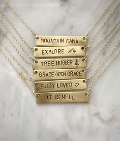 Personalize this gold bar necklace with any word that has special meaning to you or to a loved one! Give a word of encouragement to someone going through a hard time - "BRAVE" Remind her how valuable she is - "PRICELESS"Does she light up your day? If so, tell her! - "SHINE"Going on a trip? - "WANDER"Remind her it's gonna be ok. Keep your chin up - "HOPE"● 16" chain ● Completely customizable! Just message me!● Bar measures 40x8mm● Solid brass bar● Gold filled chain● Handmade by Stuart & Lisa Meaningful Everyday Gold Name Necklace, Everyday Inspirational Personalized Necklaces, Everyday Rectangular Engraved Text Necklace, Everyday Rectangular Necklace With Engraved Text, Everyday Rectangular Necklaces With Engraved Text, Meaningful Nameplate Necklace For Everyday, Inspirational Gold Hand Stamped Charm Necklace, Gold Inspirational Hand Stamped Charm Necklace, Everyday Meaningful Nameplate Necklace