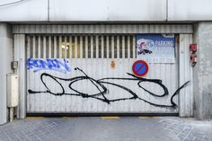 an open garage door with graffiti on it