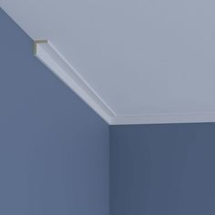 the corner of a room with blue walls and a light fixture on the ceiling above it