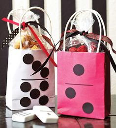 two shopping bags with polka dots on them are sitting on a table next to each other