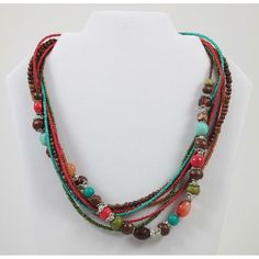 "This Boho style multi-strand beaded necklace is an 18\" long vibrant accessory, perfect for adding a pop of color to any outfit. Its bright, multi-colored beads are designed in a stylish, layered arrangement that's sure to turn heads. Beads are a mixture of glass, plastic, wood, stone, and seed beads. * Bright, multi-colored beads * Stylish multi-strand design * 18\" length * Perfect for adding a pop of color * Boho style Measurements: Length 18 in / 46 cm Extender Length 3 in / 8 cm Condition: Pre-Owned Good In wearable condition with lobster clasp. Please see photos.  We try to show all details and flaws accurately in the photos, but if you have additional questions, please let us know." Adjustable Multi-strand Necklace With Polished Beads, Adjustable Multi-strand Polished Beads Necklace, Brown Multi-strand Jewelry With Colorful Beads, Adjustable Multi-strand Beaded Necklace, Bohemian Multicolor Beaded Layered Necklace, Turquoise Beaded Multi-strand Layered Necklace, Turquoise Beaded Multi-strand Necklace, Bohemian Multi-strand Beaded Necklaces With Wooden Beads, Multi-strand Beaded Necklaces