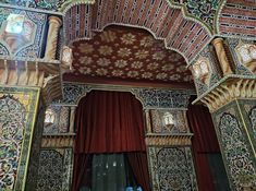 an elaborately decorated room with red curtains