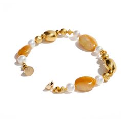 18K yellow gold, cabochon golden opal, pearl Across a medley of rich golds and yellows, Ann Ziff joins a beautiful assemblage in varying shapes and hues. Exquisite gemstones sparkle harmoniously in this delicate, yet dynamic bracelet. Interlocking high karat gold, cabochon golden opals, luminous pearls, this bracelet will drape over your wrist with unparalleled comfort and dazzling opulence. The artist creates a distinctive design as an expression to satisfy the soul. All the while, admiring the Gold Cabochon Round Beads Jewelry, Gold Opal Jewelry With Round Beads, Gold Agate Bangle Bracelet, Elegant Amber Beaded Bracelets With Natural Stones, Elegant Amber Beaded Bracelets, Elegant Yellow Gold Bracelet With Stones, Elegant Rondelle Pearl Bracelet With Gemstone Beads, Gold Agate Bangle Jewelry, Gold Beaded Bracelets With Pearl And Gemstone Beads