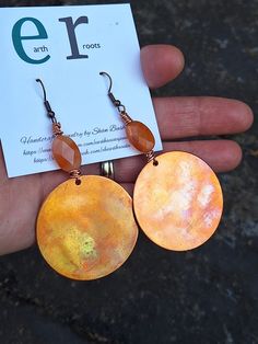 These boho style earrings are perfect for the fall season! They feature 1.5" copper blanks that have been fire painted with a propane torch to bring out the different colors in the metal.   NOTE:  Certain types of lighting will bring the colors out more in the metal than other types of lighting. They are embellished with carnelian gemstone beads.   These earrings measure just over 3" in length.  They will ship in a gift box or bag via USPS with tracking info provided. Earthy Copper Jewelry For Festivals, Hand Forged Copper Earrings For Festivals, Artsy Orange Jewelry For Festivals, Bohemian Rust Earrings With Ear Wire, Nickel Free Copper Orange Earrings, Artsy Orange Festival Jewelry, Bohemian Hand Painted Copper Jewelry, Artsy Hand Painted Copper Jewelry, Festival Hand Forged Copper Earrings