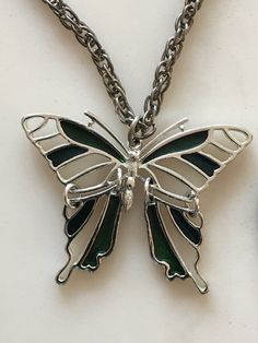 This beautiful antique butterfly pendant necklace is in excellent condition. This piece of jewelry would be a great addition to anyone's collection or as a gift. Silver Metal Butterfly Jewelry, Silver Butterfly Metal Jewelry, Metal Butterfly Clavicle Chain Jewelry, Butterfly Shaped Clavicle Chain Jewelry, Silver Butterfly Necklace With Clavicle Chain, Silver Stainless Steel Butterfly Necklace Gift, Silver Stainless Steel Butterfly Necklace As Gift, Green Butterfly Charm Pendant Necklace, Vintage Handmade Butterfly Necklace