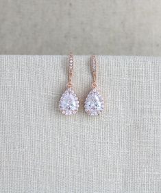 "Lovely simple rose gold earrings with amazing sparkle I created using Swarovski Pure Brilliance cubic zirconia components. - Earrings dangle 1-1/4\" - Teardrop measures 14mm x 9mm PLEASE ALLOW APPROX 3 BUSINESS DAYS FOR COMPLETION BEFORE SHIPPING. Matching necklace: https://www.etsy.com/listing/180333879/rose-gold-bridal-necklace-crystal Feel free to contact me with any questions ! Thank you for visiting ! Treasures570 Back to main page of Treasures570 for more beautiful designs https://www.ets Rose Gold Prong Set Earrings For Wedding, Dainty Sparkling Rose Gold Earrings, Rose Gold Earrings With Prong Setting For Wedding, Rose Gold Cubic Zirconia Earrings For Bridesmaids, Rose Gold Prong Setting Bridal Drop Earrings, Rose Gold Drop Bridal Earrings With Prong Setting, Rose Gold Drop Earrings With Prong Setting For Bridal, Rose Gold Drop Earrings With Prong Setting For Brides, Dainty Wedding Earrings