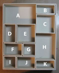 the letters and numbers are arranged in an open bookcase with compartments on each side