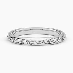 a white gold wedding band with leaves on it