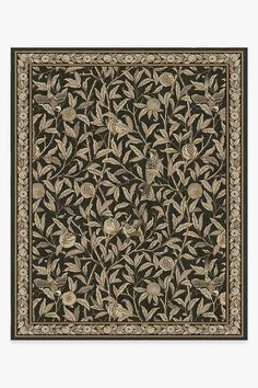 an intricately designed rug with flowers and leaves in black, beige and gold colors