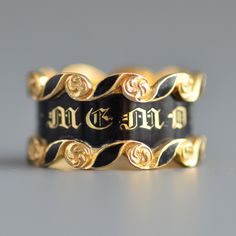 "A fantastic antique Victorian Era (1837-1901) wide mourning band ring with black enamel in 18k yellow gold. An extremely crisp and in excellent condition striking wide early Victorian period mourning ring with the central panel featuring classic gold gothic letting \"IN MEMORY OF\" and flooded with glossy black enamel, the top and bottom features swirling cartouches with black enamel and gold roses or flowers. The interior of the band is hand engraved with \"Tho's Latham died 3rd March 1843 Aet Ceremonial Black Engraved Jewelry, Black Engraved Signet Ring For Wedding, Antique Black Ceremonial Jewelry, Antique Black Jewelry For Ceremonial Occasions, Formal Black Engraved Ring With Black Enamel, Black Heirloom Ceremonial Jewelry, Black Heirloom Jewelry For Ceremonial Occasions, Black Heirloom Jewelry For Ceremonial Use, Black Engraved Ring For Collectors