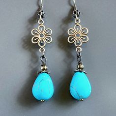 "Turquoise Teardrop Earrings - Turquoise Magnesite Teardrop Beads dangle from antiqued Brass Flower Cutouts.  The Turquoise Beads are topped with Antiqued Brass Beadcaps and Beads. Antiqued Brass  Earwires Earrings measure 2.25\" from top of earwires to bottom of beads." Elegant Turquoise Flower Earrings Nickel Free, Blue Teardrop Flower Earrings Nickel Free, Turquoise Earrings With Flower Charm As Gift, Blue Teardrop Nickel Free Flower Earrings, Turquoise Teardrop Flower Earrings For Gift, Handmade Turquoise Flower Earrings For Gift, Turquoise Nickel Free Flower Earrings, Bohemian Turquoise Flower Earrings Nickel Free, Turquoise Flower Earrings As A Gift