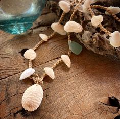 These Hawaiian ark shells look like tiny angel wings. They have been gathered from Hawaii's longest white sand beach which is known as Papohaku. This beach has a dangerous shore break that leaves these shells embedded with sand. It is also very windy most of the time so the shells usually get blown back into the ocean. Conditions must be perfect for me to find these gems.  They have been carefully drilled and crocheted with nylon cord for strength. I have added some seafoam seaglass and a bumpy cowrie for the closure. You can wear this wrap 4 times around your wrist, three times around your ankle or once or twice around your neck. When wearing as a bracelet simply wrap it around, pull the anchor shell thru the hoop, pull tight and tuck the anchor shell under one of the strands.  This one m Wire Wrapped Shell Necklace For Beach, Handmade Sand-colored Ocean-inspired Jewelry, Handmade Ocean-inspired Sand Colored Jewelry, Handmade Spiritual Shell For Beach, Handmade Spiritual Beach Shell, Beach Spiritual Hand Wrapped Necklaces, Hand Wrapped Spiritual Necklaces For The Beach, Spiritual Hand Wrapped Necklaces For Beach, Spiritual Hand Wrapped Necklace For Beach