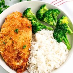 a bowl filled with rice, broccoli and chicken next to some green vegetables