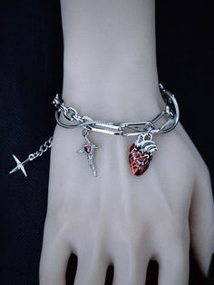 Elevate your gothic style with our handmade heart and cross charm silver bracelet. This exquisitely crafted piece features a striking combination of heart and cross charms, adding a touch of mystery and allure to your ensemble. The bracelet is meticulously handmade to ensure high quality and attention to detail.   Please note that this product includes only the bracelet. Gothic Silver Jewelry, Silver Emo Jewelry For Valentine's Day, Heart And Cross, Red Gothic, Gothic Bracelet, Edgy Jewelry, Gothic Vintage, Gothic Earrings, Gothic Accessories