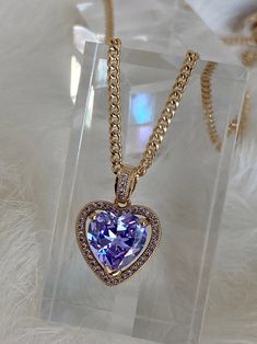 The Mini Lavender Heart Necklace is so dreamy! This bombshell features a light lavender heart-shaped cubic zirconia stone embraced in a micro pave encrusted frame suspended from a dainty chain! Get your hands on this centerfold or one of her glitzy besties below: - The Mini Ruby Heart Necklace - The Mini Crystal Heart Necklace - The Mini Pink Heart Necklace Available in 24K gold or rhodium plating over steel Patent plating & sealant technology to ensure durability and long lasting wear Made Heart Gem Necklace, Purple Heart Cut Cubic Zirconia Jewelry, Purple Cubic Zirconia Jewelry For Valentine's Day, Purple Double Heart Charm Jewelry, Purple Double Heart Jewelry With Heart Charm, Valentine's Day Purple Diamond Jewelry, Elegant Purple Heart Cut Necklace, Lavender Things, Purple Heart Necklace