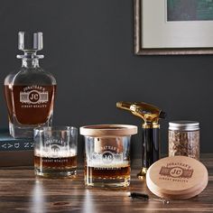 an assortment of personal care items sitting on a table next to a bottle of whiskey