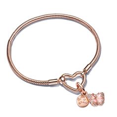 Embody the beauty of change, personal growth and positive transformation with a bracelet set that's truly one of a kind. The Pandora Moments Heart Closure Snake Chain Bracelet, hand-finished with 14k rose gold plating, gracefully showcases the Pink Butterfly & Quote Double Dangle Charm. This spring-inspired charm dazzles with two distinct 14k rose gold-plated charms: the first, a round disk with tiny butterflies on one side and the engraved words, "One of a Kind" on the other; the second, a read Pandora Pjnk And Gold Charm Bracelet, Rose Gold Heart Charm Jewelry For Promise, Rose Gold Heart Charm Bracelet, Rose Gold Jewelry With Heart Charm For Promise, Rose Gold Promise Jewelry With Heart Charm, Feminine Rose Gold Jewelry With Heart Charm, Elegant Jewelry With Removable Heart Charms, Elegant Pink Bracelet With Heart Charm, Elegant Rose Gold Bracelets With Charms