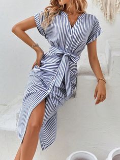 Elevate your style with our Chic and Playful dress! Featuring a flattering striped print, flowy batwing sleeves, and a belted waist for a perfect fit. Stay fashionable and comfortable with this versatile dress, perfect for any occasion. Expertly designed for a confident and stylish look. Color : Blue and White Style : Casual Pattern Type : Striped Sleeve Length : Short Sleeve Details : Belted Neckline : Notched Details : Button Front Type : Fitted Sleeve Type : Batwing Sleeve Waist Line : High Waist Hem Shaped : Straight Length : Long Fit Type : Regular Fit Fabric : Non-Stretch Material : Fabric Composition : 64% Polyester Composition : 36% Cotton Care Instructions : Machine wash or professional dry clean Belt : Yes Sheer : No Size US Belt Length Bust Cuff Hip Size Length Sleeve Length Wai Elegant Striped Belted Dress, Striped Belted Dresses For Daywear, Striped Belted Dress For Spring, Spring Striped Belted Dress, Summer Striped Dress With Tie Waist, Striped Summer Dress With Tie Waist, Chic Striped Belted Dress, Elegant Striped Midi Dress For Vacation, Striped Tie Waist Dress For Day Out