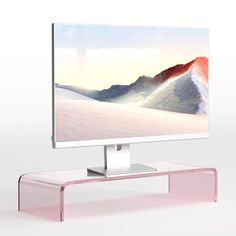 a flat screen tv sitting on top of a white table next to a pink shelf