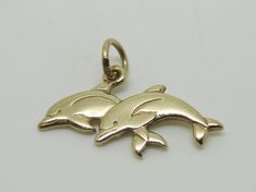 This beautiful charm is an authentic James Avery piece in yellow gold stamped with the candle sticks 14K ©. The charm is called Twin Dolphins and it is a retired piece and a very rare find. The charm measures 1" in length and the jump ring is cut. The charm does not come in its original packaging. RING SIZE: N/A TOTAL WEIGHT: 2.3 Grams CONDITION: Excellent REF. CODE: LB3416 Feel free to Visit My ebay Store and browse through my other items for some more unique fine jewelry and collectibles. All Vintage 14k Gold Engraved Charms, Vintage Engraved 14k Gold Charms, Elegant 14k Gold Charms For Collectors, Elegant 14k Gold Collectible Charms, Heirloom 14k Gold Charms For Gifts, Heirloom Yellow Gold Charms For Gift, Vintage Yellow Gold Charms Stamped 14k, Vintage Yellow Gold Charms For Anniversary, Vintage 14k Stamped Yellow Gold Charms