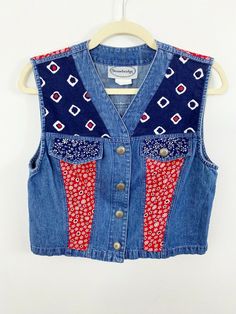 Stonebridge Denim Sleeveless Vest Size Medium Red Floral Blue Geometric Country Very good preowned condition - MISSING A BUTTON ON ONE OF THE FAUX POCKETS No holes or stains Measurements lying flat: pit to pit 18", length 17" Prairie, Country, Ranch, Western Smoke and pet free home Sleeveless Denim Vest For Festivals, Summer Sleeveless Denim Vest With Patchwork, Sleeveless Patchwork Denim Vest For Summer, Summer Sleeveless Patchwork Denim Vest, Red Vintage Vest For Summer, Red Vintage Summer Vest, Vintage Red Vest For Summer, Vintage Patchwork Vest For Summer, Blue Cotton Retro Denim Vest