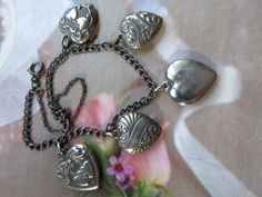 "This 1940s sterling puffy heart charm bracelet was purchased intact from a local estate. It would make a wonderful Valentines Day gift. It is a very special vintage charm bracelet that could be the start of a family heirloom collection to for a bride to be. Vintage sterling heart charm bracelets are very collectible and this one is all the more special with it's two Walter Lampl hearts. Walter Lampl charms were given to guests on the TV show \"This Is Your Life\" back in the 1950s. His jewelry Victorian Bracelets With Vintage Charm As Gift, Victorian Style Bracelet With Vintage Charm For Gift, Vintage Nickel-free Heart Bracelet As Gift, Vintage Nickel-free Heart Bracelet Gift, Vintage Charm Bracelet With Heart Charm, Nickel-free Vintage Heart Bracelet As Gift, Vintage Heart Charm Bracelet As A Gift, Vintage Heart-shaped Bracelets With Charm, Vintage Heart Charm Bracelet For Gift