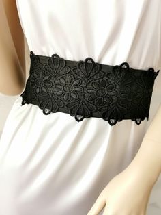 If you would like this belt in a different length or width, please, write to us. The Black wide satin belt with lace. This extra long sash is 3 inches wide and 100 inches long. The length of the lace on the belt is 20 inches. Belt material: stretch satin, lace. The satin belt is available in the following colors: 1 White 2 Ivory 3 Champagne 4 Beige 5 Peach 6 Light pink 7 Pink 8 Lilac 9 Dark pink 10 Red 11 Burgundy 12 Terracotta 13 Gray 14 Dark brown 15 Black  16 Dark green 17 Sky blue 18 Royal blue 19 Navy blue  20 Aqua blue Wedding Black Fitted Corset Belt, Lace Corset Belt For Wedding, Lace Wedding Corset Belt, Elegant Lace Corset Belt, Elegant Black Corset Belt For Party, Elegant Lace Wedding Corset Belt, Elegant Wedding Lace Corset Belt, Elegant Fitted Corset Belt With Lace Trim, Elegant Black Party Belt