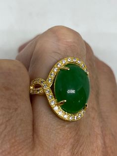 Vintage Lucky Green Nephrite Jade ring Fun jade is color enhanced Large green nephrite jade Ornate German Gold finished Vintage ring, does not tarnish, NOT sterling Size 6, 7, 8, or 8.75 All rings are shipped free in the US in a nice gift box. Check out our over a THOUSAND great reviews Engraving is $4 per letter and is not always perfect depending on the piece. It can take a few days if the jeweler is busy. This is payable to Paypal Judithsltd@gmail.com Green Oval Rings With Stone Setting, Oval Green Rings With Stone Setting, Green Gemstone Ring With Stone Setting, Green Oval Stone Setting Rings, Green Gemstones With Stone Setting For Anniversary, Green Oval Jade Ring, Fine Jewelry Green Oval Cabochon Rings, Vintage Jade Gemstone Jewelry, Green Cabochon Round Stone Rings