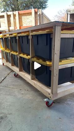 a wooden cart with several bins on it