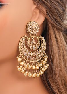 These Polki earrings are a classic addition to any traditional outfit with their stunning stones, crystals, and pearls. They add an exquisite charm and make for the perfect accessory to complete your look. Earrings length: Approx. 3.5" Weight of each earring: 31 gms Push-Back Closure. Antique Gold Plated on high-quality brass as the base metal In-stock & ready-to-ship Color may vary slightly due to light condition & photography. Jewelry Care: Keep away from moisture. Allow perfumes and lotion to Gold Crystal Earrings, Onam Earrings, Chandbali Earrings Gold Antiques, Golden Earrings Indian, Ear Rings Gold Indian, Big Earrings Indian, Kashmir Outfits, Chandbali Earrings Gold, Earrings For Saree