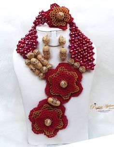 PrestigeApplause Latest Design Dark Red & Gold Elongated African Nigerian Necklace Jewellery Set Complete Set is Necklace Earring and bracelet Comes with 2 styles of versility  Wedding Party Bridal Special Occasion This detailed Jewellery set makes you stand out elegantly in any special occassion, it's all about glamour and uniqueness.  Buying more that 1 Jewellery set, we offer wholesale and bulk prices for all our jewellery. Elegant Red Beaded Jewelry Set, Adjustable Handmade Red Jewelry Sets, Handmade Adjustable Red Jewelry Sets, Handmade Red Jewelry Sets For Party, Elegant Red Beaded Jewelry, Traditional Red Crystal Jewelry Sets, Traditional Red Crystal Necklace, Red Beaded Jewelry For Party, Handmade Red Beads For Costume Jewelry