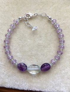 "This bracelet is one of a kind!  Beautiful Amethyst gems and a Prasiolite focal.  The gems are of the highest quality and strung on quality jewelry wire for strength and longevity.  The size is adjustable from 7\" to 7-1/2\"." Herkimer Diamond Earrings, Amethyst Gem, Jewelry Wire, Herkimer Diamond, Shell Earrings, Quality Jewelry, Clear Crystal, Wire Jewelry, Diamond Earrings