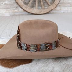 1 Unit    Width: 3 cm  Length: approx. 58cm (not including leather ties)  One size fits most. Adjustable with leather ties  Center crest measures 5" W x 4.5" H.  CA Residents: Prop 65 Warning ↗️ Feather Hat Band, Feather Hat, Hat Band, Leather And Lace, Band, Hats, Lace, Leather