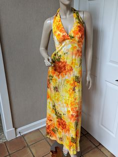 "Vintage Hawaiian Dress Great 1970's dress by Kiyomi of Hawaii, \"LH\" Liberty House.  It is halter style with some stretch in the back, ties at neck with back zipper.The bust is padded but there is no support.  There is a pocket on one side.  It's a bright yellow with orange tropical floral print, \"all acrylic\".  It has the original tag attached and is tagged a vintage size 10.  Probably more like a size 6 in today's sizing.  It is a great vintage, preowned  condition with no issues that I see. Measurements;  Bust=36\", Waist=28\", Hips=40\", Length measured from waist  is  about 38\"" Hawaiian Clothes, Hawaiian Halter Dress, Vintage Hawaiian Dress, Liberty House, Party Inspo, 1970s Dresses, Hawaiian Outfit, Tropical Floral Print, Hawaiian Dress