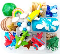 a plastic container filled with different types of toy airplanes and other toys on top of it