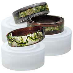 three different types of rings with trees on them