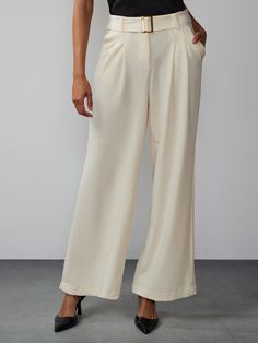 Achieve a timeless and versatile style that suits any occasion in this chic pair of pants. Crafted with meticulous attention to detail, these pants feature a high rise waist, elegant pleats, and a flattering wide leg silhouette that exudes sophistication. Pair them with a tucked-in blouse and heels for a polished office look. Elegant Wide Leg Bottoms For Semi-formal Occasions, Timeless Formal Wide Leg Pants, Elegant Wide Leg Pants With Pressed Crease, Timeless Wide Leg Formal Pants, Modern Wide Leg Pants With Welt Pockets, Elegant Tailored Wide-leg Pants, Timeless Semi-formal Wide Leg Bottoms, Tailored Wide Leg Dress Pants, Chic Wide-leg Workwear Bottoms