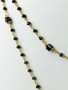 Black diamond rosary necklace with cube diamond accents. Necklace is 14k yellow gold. Round black diamonds range from 22mm - 2.3mm and cubes are 2.7-3mm on each side. metal - 14k Yellow Gold Diamonds - 15cts (estimated) Length - 37" Yellow Gold Black Spinel Jewelry As A Gift, Yellow Gold Necklace With Black Diamonds As Gift, Luxury Gold Jewelry With Black Beads, Fine Jewelry In Gold With Black Diamonds, Fine Jewelry In Yellow Gold With Faceted Beads, Fine Jewelry With Black Diamonds In Gold, Yellow Gold Jewelry With Faceted Beads For Gift, Fine Jewelry Gold Jewelry With Black Diamonds, Fine Jewelry Gold With Black Diamonds