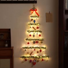 a christmas tree made out of lights on the side of a wall in a living room