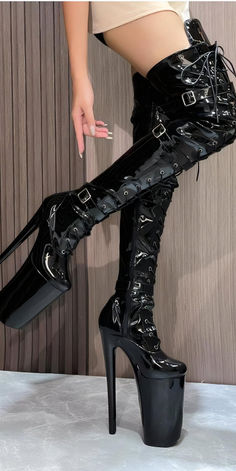 Discover the ultimate statement piece for your wardrobe with these Black Patent Leather Platform Ivory Thigh-High Boots. Perfect for clubbing, parties, or making any outfit stand out. These stylish boots are crafted from high-quality patent leather with a secure lace-up design and multiple buckles. Shop now and enjoy free returns and size exchanges. Elevate your style and confidence with every step! Thigh High Black Boots, Stiletto Boots, Platform Stilettos, Stylish Boots, Thigh High Boots, Thigh High, Black Patent Leather, Thigh Highs, High Boots