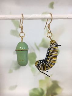 a pair of earrings hanging from a hook