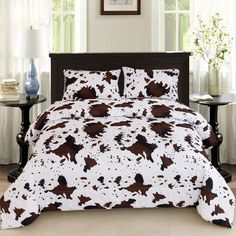 a bed with brown and white cow print on it