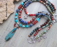 Colorado Springs, Boho Style Me Colorful Rustic Style Multi Strand Gemstone Necklace, BohoStyleMe, Artisan Beaded Turquoise Necklace In the style of the rustic Colorado mountains, this colorful, rustic, mixed gemstone necklace stands out as a striking multiple strand statement necklace. Starting with a beautiful chrysocolla beaded pendant is a trail of genuine turquoise, lapis lazuli, carnelian, labradorite, iolite, sodalite, and a large mix of jasper stones. Directly above the pendant is strand with a row of gorgeous lapis disc beads, labradorite, and mixed jasper stones. The top strand holds a pewter templars cross, surrounded my additional gemstones. Pewter is used throughout, as well as mixed silver metal - enjoy! Length - 30 inches (longest), 24 inches (shortest). Chrysocolla pendant Green Bohemian Beaded Necklaces With Stones, Bohemian Green Beaded Necklaces With Stones, Bohemian Beaded Turquoise Necklace For Meditation, Bohemian Beaded Necklaces With Round Stones, Bohemian Blue Beaded Necklaces With Stones, Multicolor Hand-strung Spiritual Turquoise Necklace, Blue Bohemian Beaded Necklaces With Stones, Handmade Multicolor Bohemian Turquoise Necklace, Spiritual Multicolor Hand-strung Turquoise Necklace