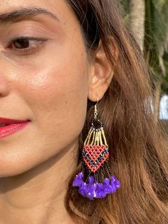 Kalbeliya Gypsy Tribal Earrings- Purple Rain Handmade Kalbeliya earrings with sterling silver posts in glorious color combos of beaded work and tassels. These bold beauties mimic the flamboyancy of the Kalbeliya tribal people. Each pair is made by a woman, a dancer from the tribe, named Moriya. She makes each piece with love and an eagerness to demonstrate a taste of her culture. Kalbeliya tribe people are known for snake charming and trading snake venom. They are also called Saperas or Snake Ch Festive Fusion Dangling Beads Earrings, Traditional Multicolor Jewelry With Beaded Fringe, Traditional Beaded Earrings For Celebrations, Traditional Chandelier Earrings With Dangling Beads, Beaded Earrings For Festivals And Celebrations, Traditional Celebration Beaded Earrings With Round Beads, Purple Beaded Fringe Earrings As Gift, Purple Beaded Fringe Drop Earrings, Festival Jewelry With Beaded Fringe